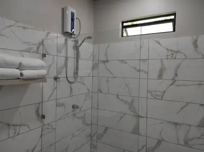 a bathroom with a shower with marble tiles at Mandy Loft -40MB wifi -8 miles from La Fortuna in San Ramón