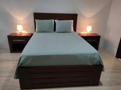 a bedroom with a large bed with two night stands at Mandy Loft -40MB wifi -8 miles from La Fortuna in San Ramón