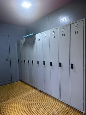 a row of white lockers in a locker room at Capsule Pupa House in Tamarindo