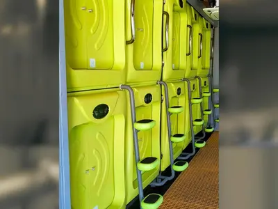 a row of yellow bins on a train at Capsule Pupa House in Tamarindo
