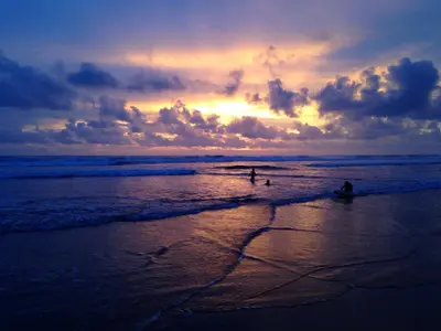 two people are in the water at the beach at Rafiki Beach Camp in Matapalo