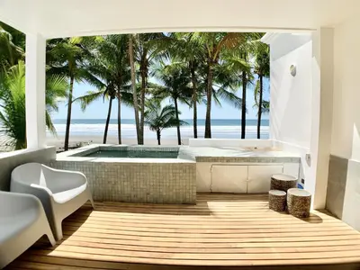a bathroom with a soaking tub and a view of the beach at Modern Beachfront Paradise - Hermosa Palms 8 in Playa Hermosa