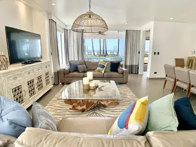 a living room with a couch and a table at Modern Beachfront Paradise - Hermosa Palms 8 in Playa Hermosa