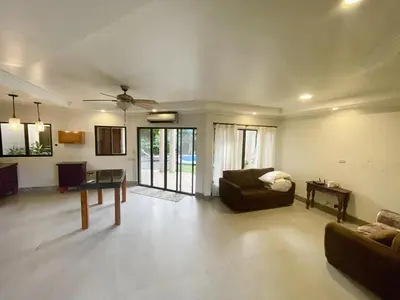a living room with a couch and a table at Villa Arenas- Private Pool & Easy Beach Access in Jaco in Jacó