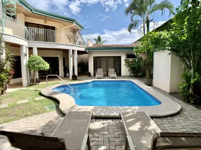 a swimming pool in the backyard of a house at Villa Arenas- Private Pool & Easy Beach Access in Jaco in Jacó