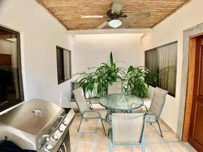 a dining room with a glass table and chairs at Villa Arenas- Private Pool & Easy Beach Access in Jaco in Jacó