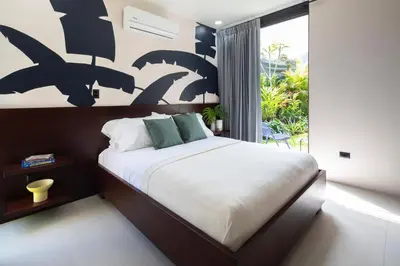 a bedroom with a bed and a large window at BAUMA in Fortuna