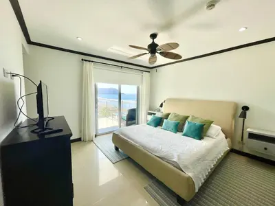 a bedroom with a bed and a ceiling fan at Ocean View, Luxury Penthouse at Diamonte del Sol 702N in Jacó