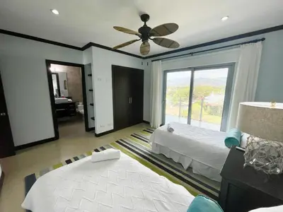 a bedroom with a bed and a ceiling fan at Ocean View, Luxury Penthouse at Diamonte del Sol 702N in Jacó