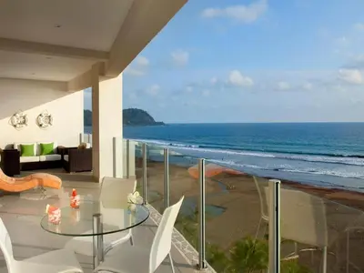 a balcony with a table and chairs and the ocean at Ocean View, Luxury Penthouse at Diamonte del Sol 702N in Jacó