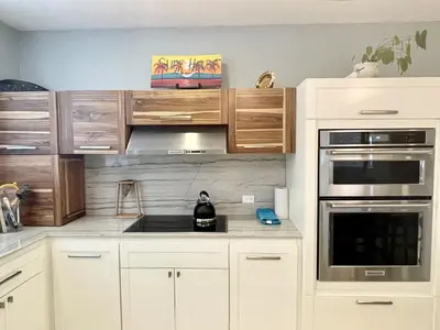 a kitchen with white cabinets and stainless steel appliances at Luxury Beachfront Oasis - Hermosa Palms 50 in Playa Hermosa