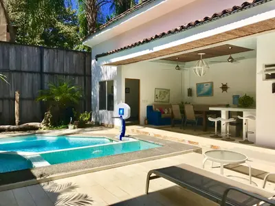 a swimming pool in a backyard with a house at Luxury Beachfront Oasis - Hermosa Palms 50 in Playa Hermosa
