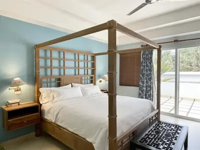 a bedroom with a canopy bed and a window at Luxury Beachfront Oasis - Hermosa Palms 50 in Playa Hermosa