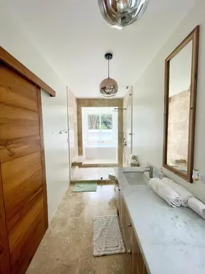 a bathroom with a sink and a mirror at Luxury Beachfront Oasis - Hermosa Palms 50 in Playa Hermosa