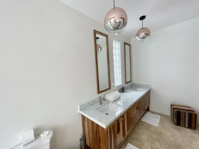 a bathroom with a sink and a mirror at Luxury Beachfront Oasis - Hermosa Palms 50 in Playa Hermosa