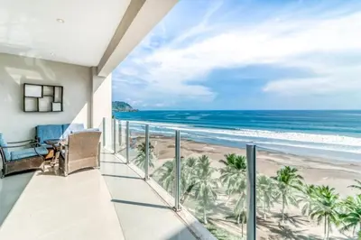 a balcony with a view of the beach at Elegant Beachfront Condo at Diamonte del Sol - 801s in Jacó