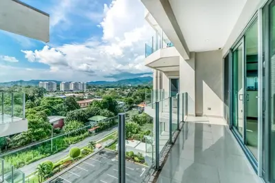 a balcony with a view of a city at Elegant Beachfront Condo at Diamonte del Sol - 801s in Jacó