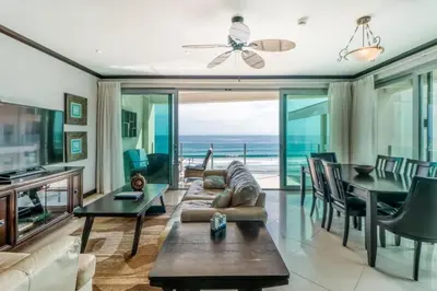 a living room with a view of the ocean at Elegant Beachfront Condo at Diamonte del Sol - 801s in Jacó