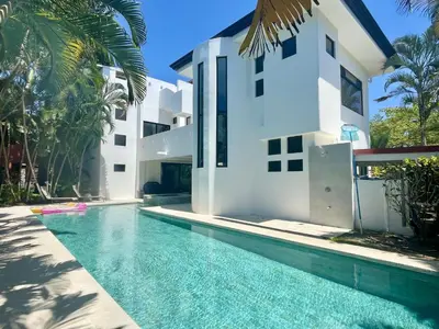 a swimming pool in front of a house at Classy Beachfront Home with Private Pool - Hermosa Palms 110 in Playa Hermosa