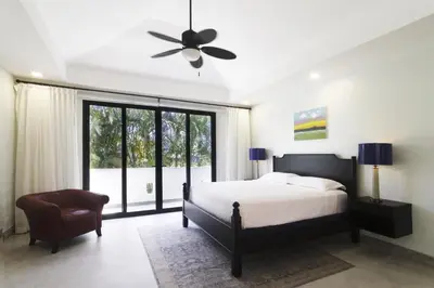 a bedroom with a bed and a ceiling fan at Classy Beachfront Home with Private Pool - Hermosa Palms 110 in Playa Hermosa