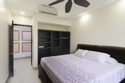 a bedroom with a bed and a ceiling fan at Classy Beachfront Home with Private Pool - Hermosa Palms 110 in Playa Hermosa