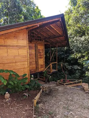 a small wooden building with a roof at Yogachal Vista Mar Bamboo House in the Jungle in Ojochal