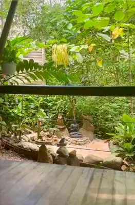 a view of a garden with a small statue at Yogachal Vista Mar Bamboo House in the Jungle in Ojochal