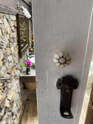 a door with a door knob on it with a stone wall at Jicote finca de ecoturismo 2 in Cartago