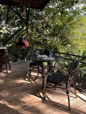 a patio with a table and chairs on a deck at Jicote finca de ecoturismo 2 in Cartago