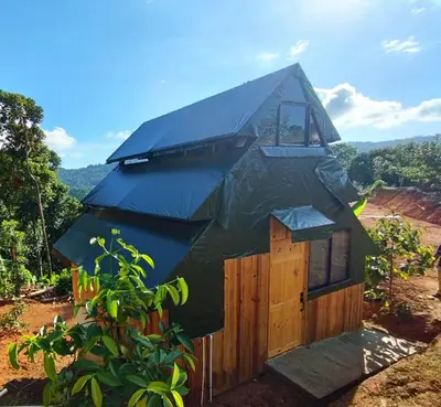 a tree house with a roof on top of it at Finca Makambu in Platanillo