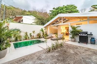 a home with a swimming pool and a house at Casa Bonimus in Santa Teresa Beach