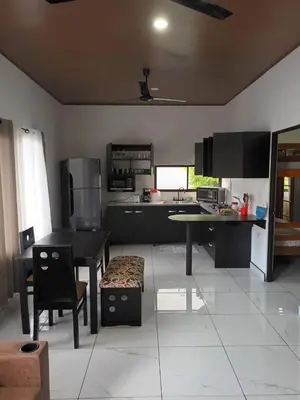 a kitchen with a table and a table and chairs at Apartamento Rodriguez in Quepos