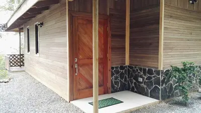 a wooden door on the side of a house at Mirador Valle del General in La Ese