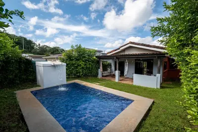 a swimming pool in the yard of a house at Casa Aqua in Tamarindo