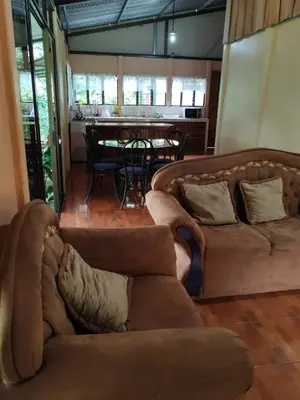 a living room with two couches and a table at Natural paradise in Turrialba