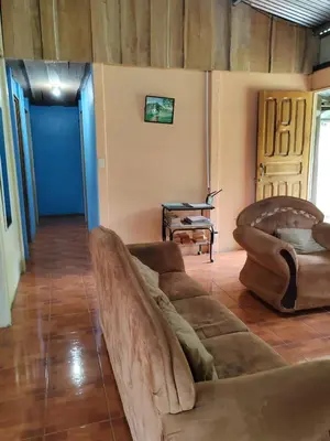 a living room with a couch and a table at Natural paradise in Turrialba