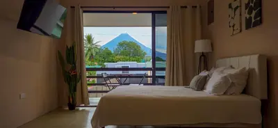 a bedroom with a bed and a view of a mountain at Rooftop and stunning Arenal Volcano views 3 minutes from La Fortuna in Fortuna