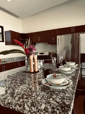 a kitchen with a marble counter top with dishes on it at Casa Principe in Uvita