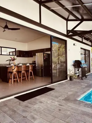 an open kitchen and dining area of a house at Casa Principe in Uvita