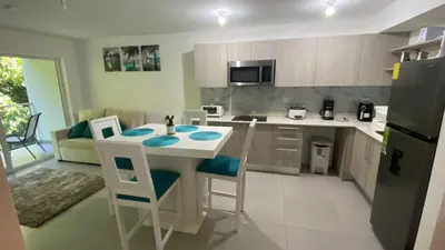 a kitchen with a island in the middle of a room at Punta Esmeralda by Punta Leona in Jacó