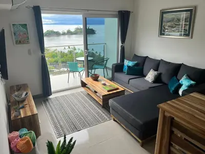 a living room with a couch and a table at Punta Esmeralda by Punta Leona in Jacó