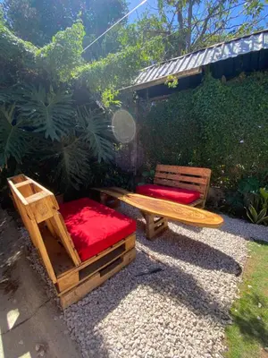 two chairs and a table and a bench in a yard at Gamboa Lodging 2 in Liberia