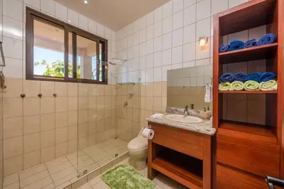 a bathroom with a sink and a toilet and a mirror at Casa Del Mar- 3 Br Ocean View House In Flamingo in Playa Flamingo
