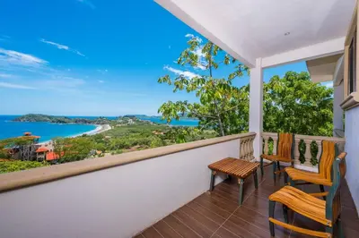 a balcony with chairs and a view of the water at Casa Del Mar- 3 Br Ocean View House In Flamingo in Playa Flamingo