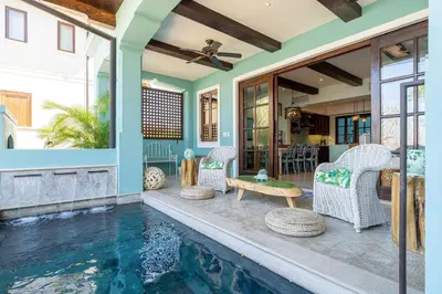 a house with a swimming pool with chairs and a table at Casa De Los Sueños - 3 Bedroom Home At Las Catalinas in Playa Danta