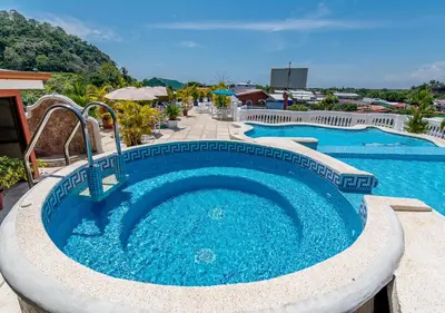 a large pool with blue water in a resort at Hotel Le Priss in Manuel Antonio
