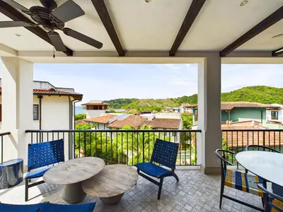 a patio with a table and chairs and a balcony at Casa Virginia #5 Private Pool -Ocean View At Las Catalinas in Playa Danta