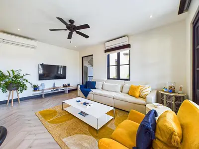 a living room with a couch and a ceiling fan at Casa Virginia #5 Private Pool -Ocean View At Las Catalinas in Playa Danta