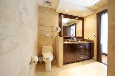 a bathroom with a toilet and a sink and a mirror at 360 Splendor 407 -Ocean View -Breakfast Included! in Playa Flamingo