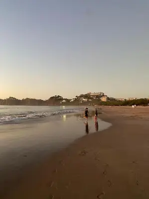 a couple of people walking on the beach at Casa Pacifico 46 Tamarindo in Santa Cruz